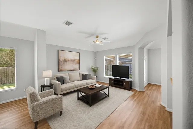 a living room with furniture and a flat screen tv