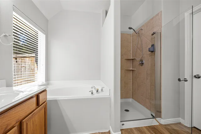 a bathroom with a bathtub and a shower