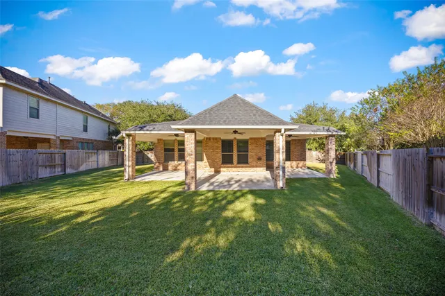 a backyard of a house with table and chairs