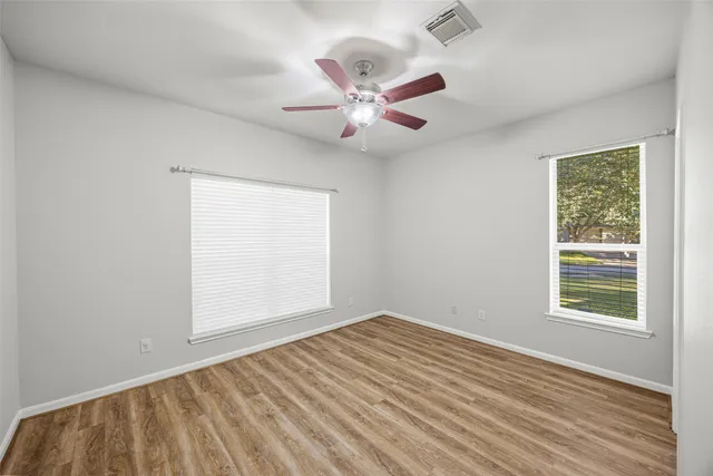 wooden floor in an empty room with a window