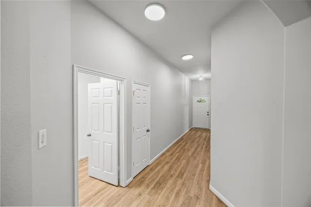 a view of hallway with wooden floor
