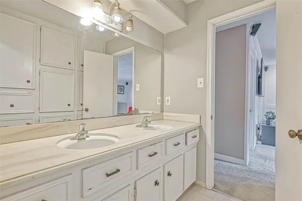 a bathroom with double sink and a mirror