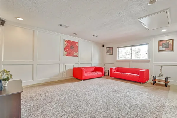 a spacious bedroom with furniture and window