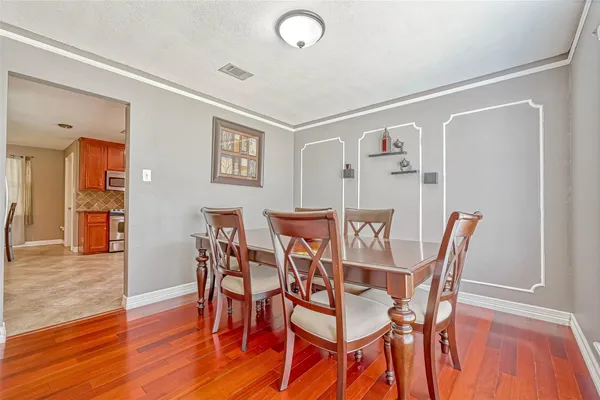 a view of a dining room with furniture and wooden floor