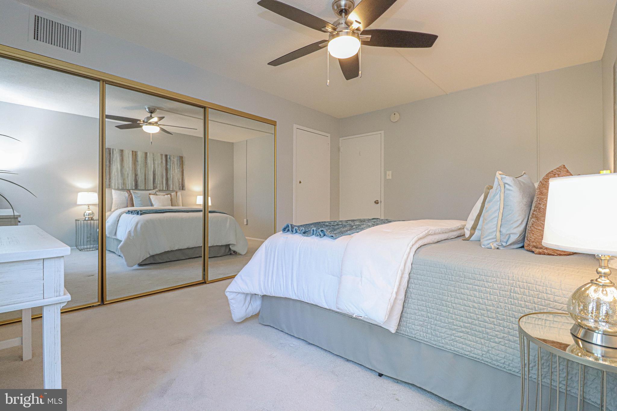 700 7th Street Southwest, Unit 608 Washington, DC 20024 - Photo 16 of 45 a bedroom with a large bed and a chandelier