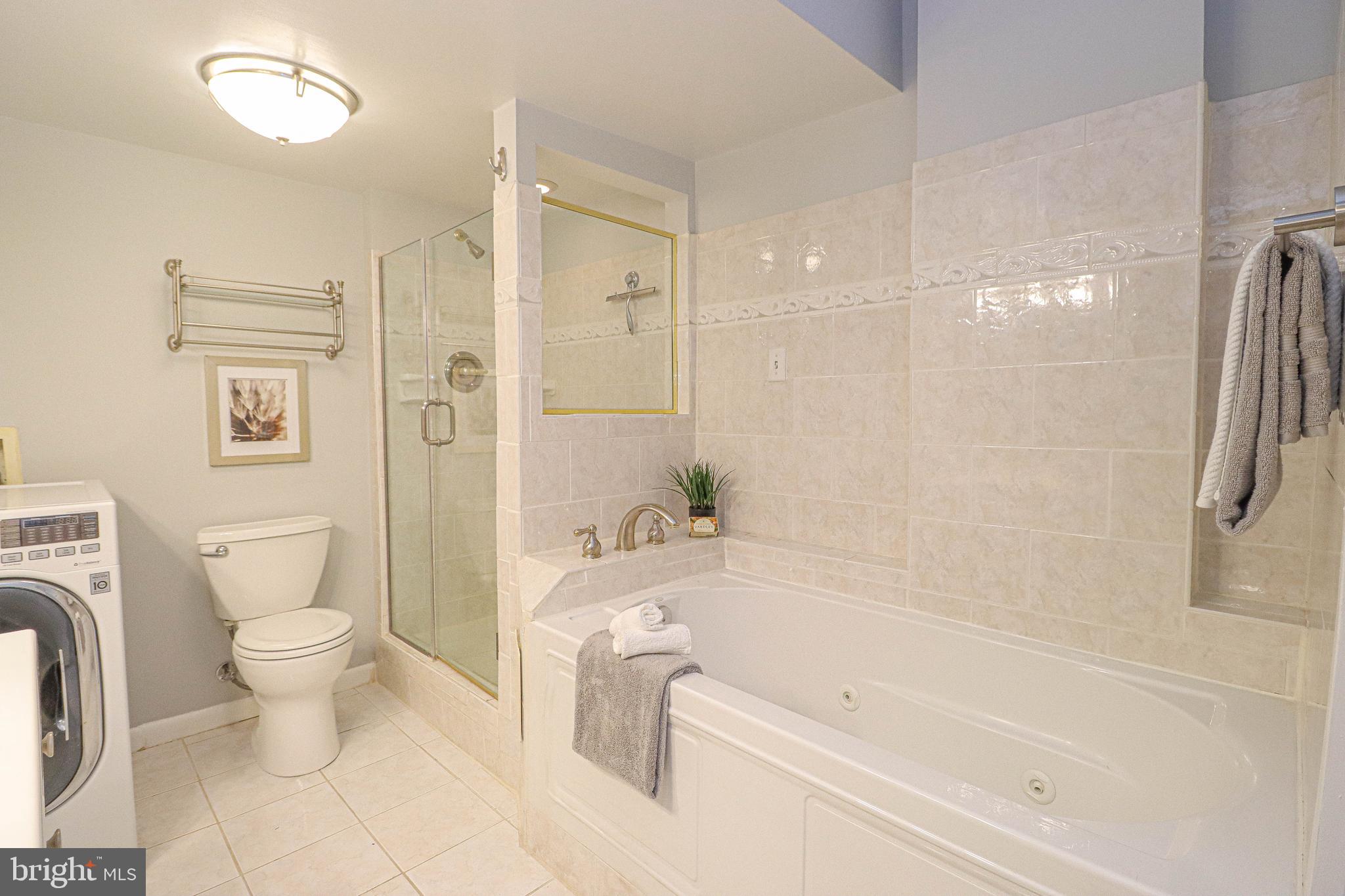 700 7th Street Southwest, Unit 608 Washington, DC 20024 - Photo 18 of 45 a bathroom with a bathtub toilet and a shower