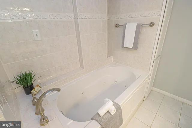 a bathroom with a bathtub shower sink and toilet