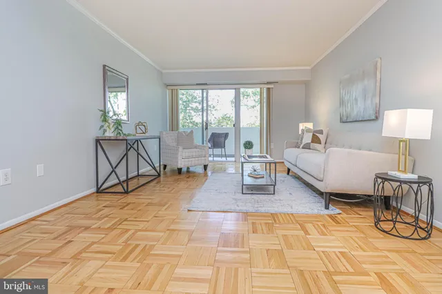 a living room with patio furniture and a dining table