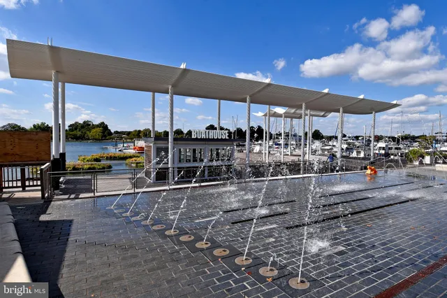 a roof deck with table and chairs