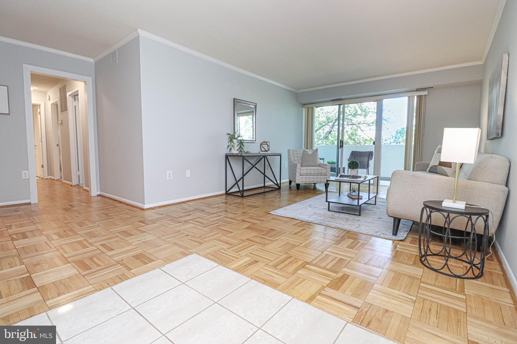 700 7th Street Southwest, Unit 608 Washington, DC 20024 - Photo 3 of 45 a living room with patio furniture and a dining table