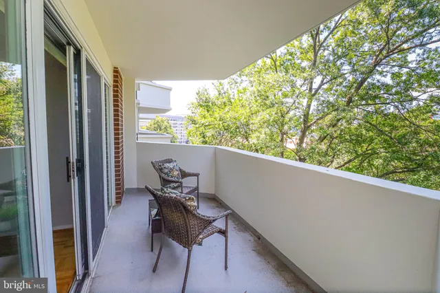a wooden bench sitting in front of a building