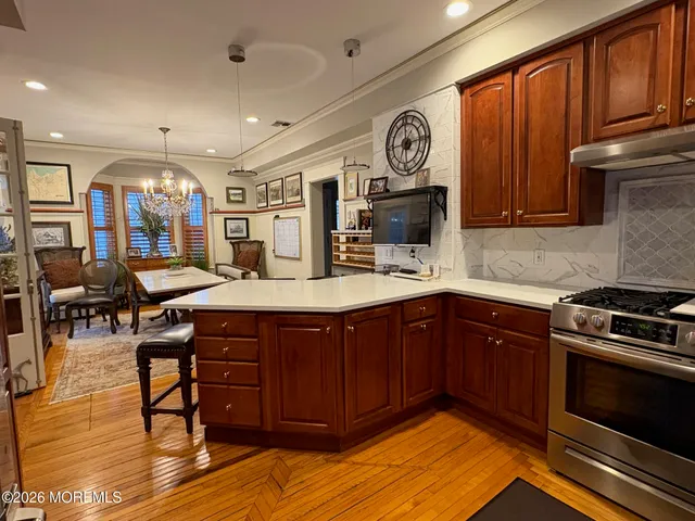 a kitchen with a sink cabinets and wooden floor