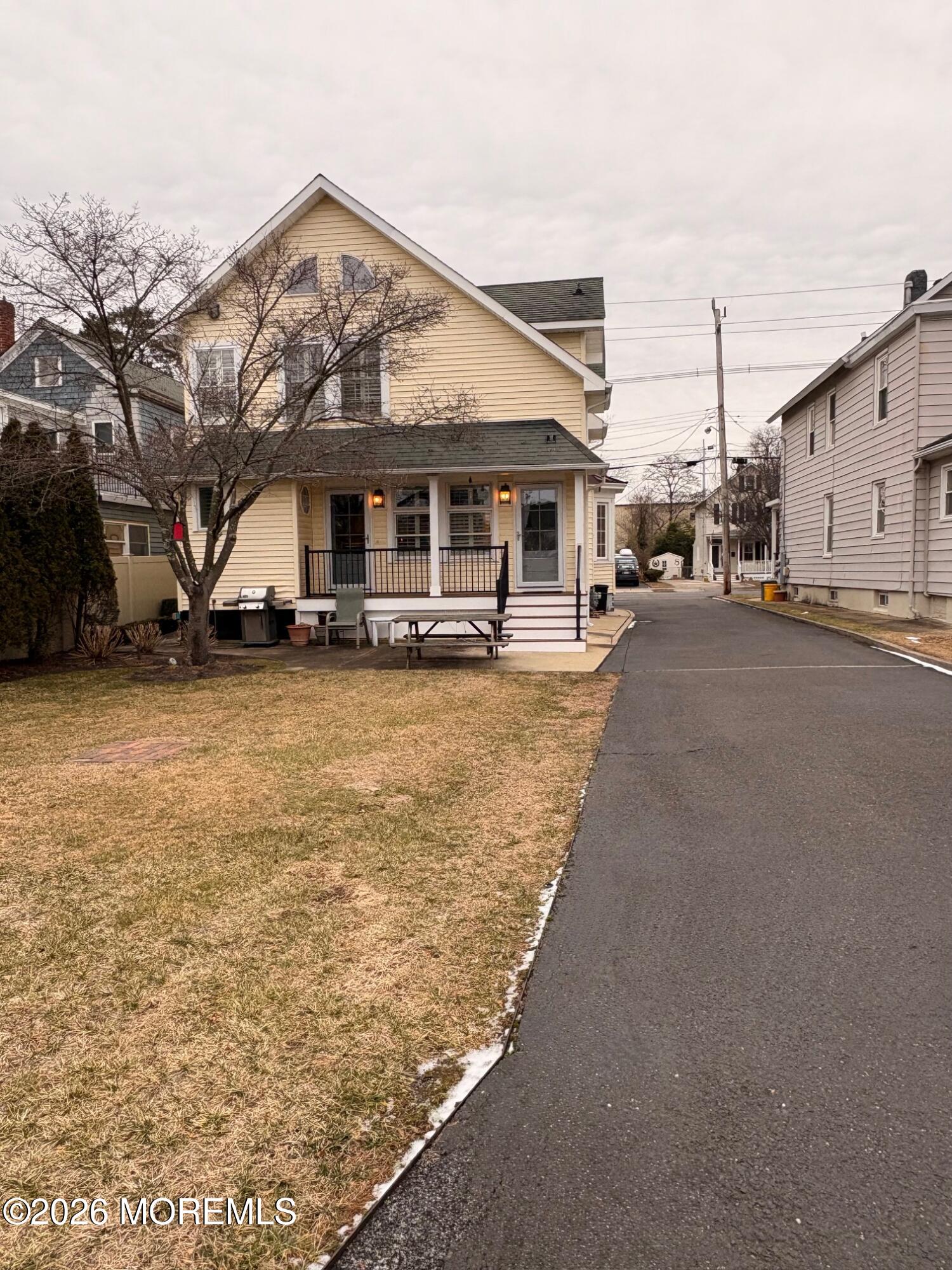 162 Bridge Avenue Red Bank, NJ 07701 - Photo 25 of 27 a view of a white house next to a road with big trees