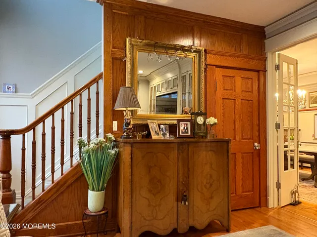a view of a hallway with wooden floor and glass door