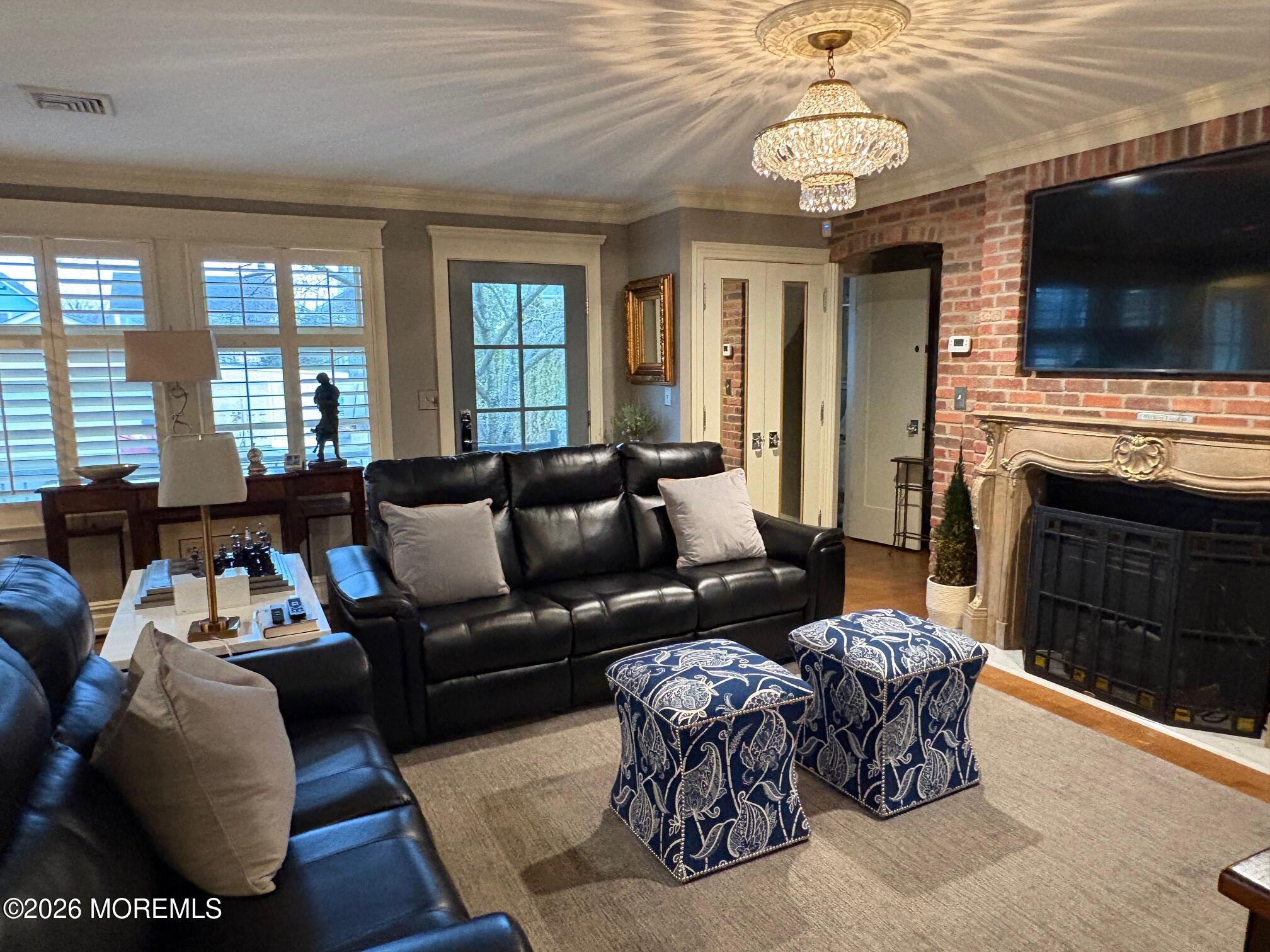 162 Bridge Avenue Red Bank, NJ 07701 - Photo 10 of 27 a living room with furniture a flat screen tv and a fireplace