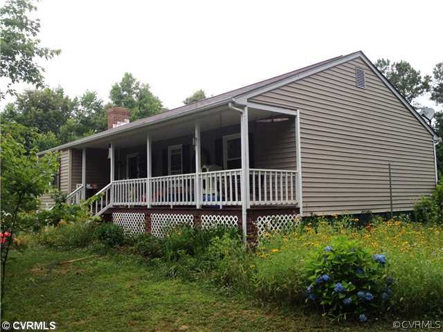 1471 Signboard Road Bumpass, VA 23024 - Photo 1 of 1 a view of a house with a small yard and plants