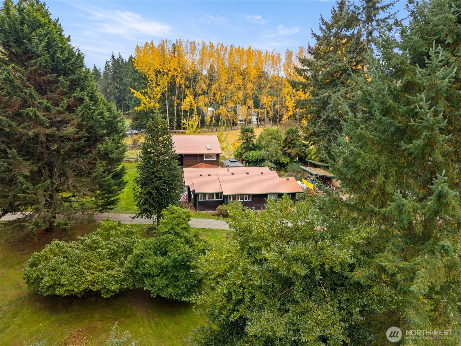 an aerial view of a house with swimming pool outdoor seating and yard