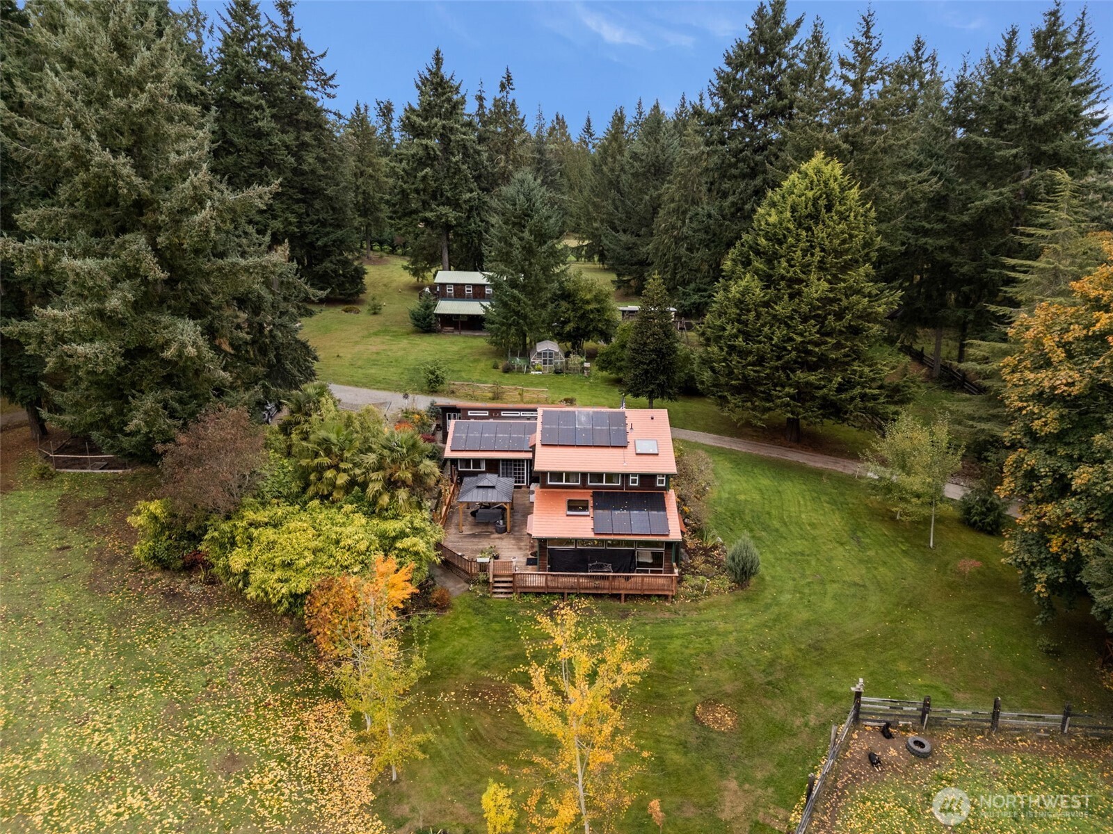 an aerial view of a house with swimming pool a yard and a fountain