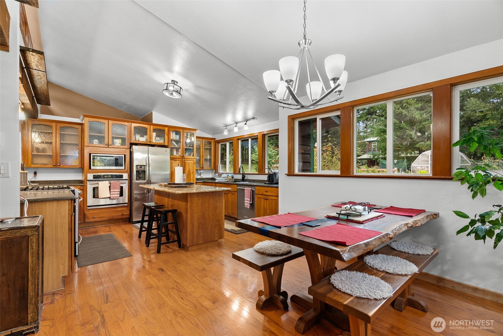 4914 182nd Avenue Southwest Longbranch, WA 98351 - Photo 16 of 40 a view of a dining room with furniture window and wooden floor