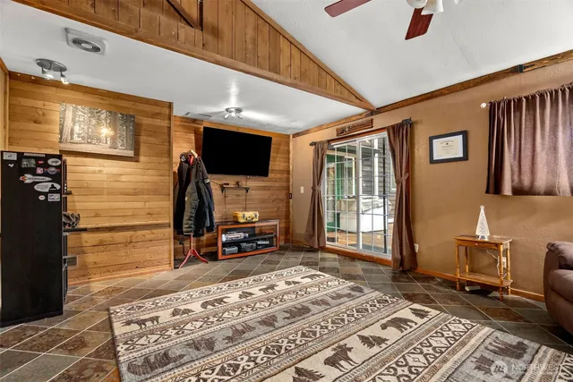 a living room with fireplace furniture and a flat screen tv