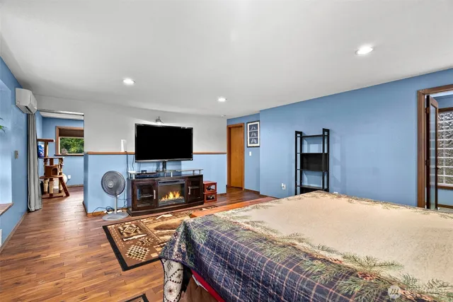 a bedroom with a bed and a flat screen tv