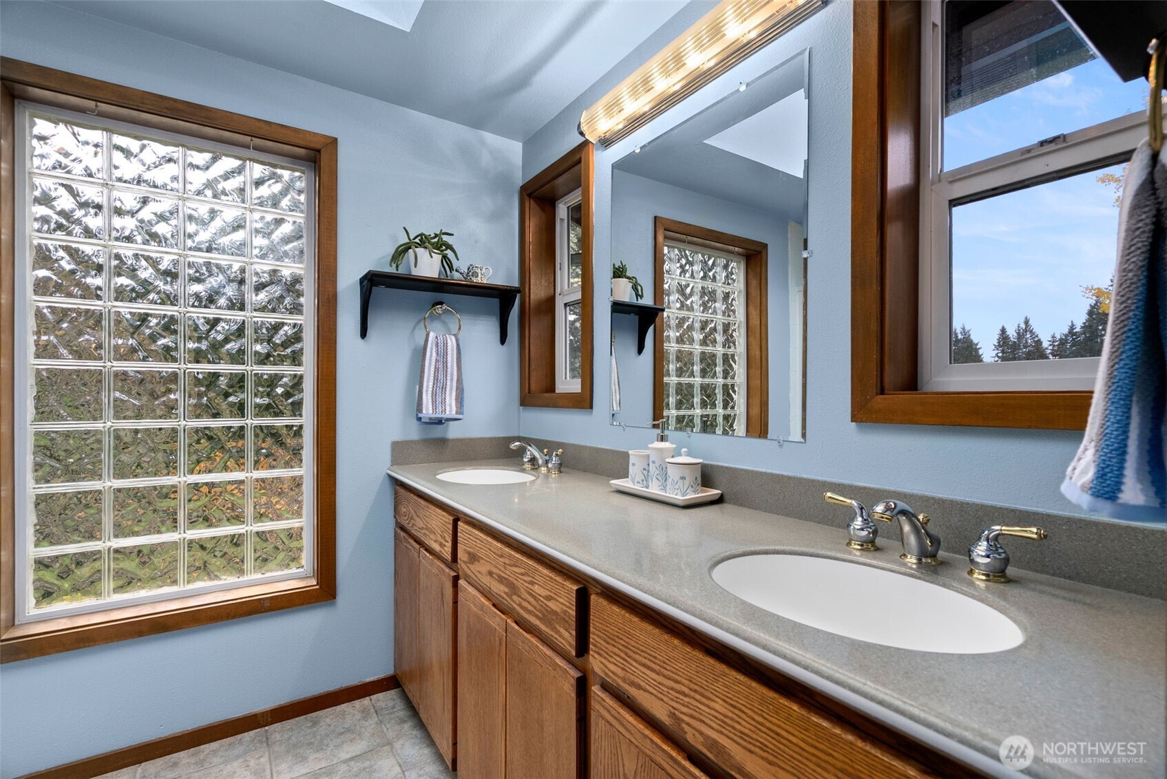 4914 182nd Avenue Southwest Longbranch, WA 98351 - Photo 31 of 40 a bathroom with a granite countertop sink and a mirror