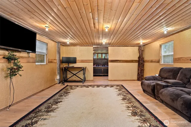 a living room with furniture a flat screen tv and a table