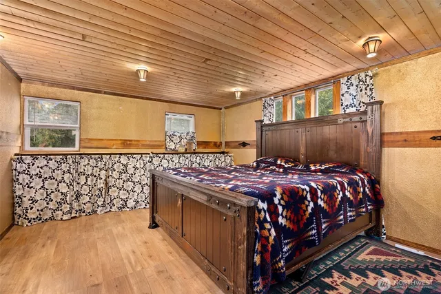 a bed sitting in a bedroom next to a window