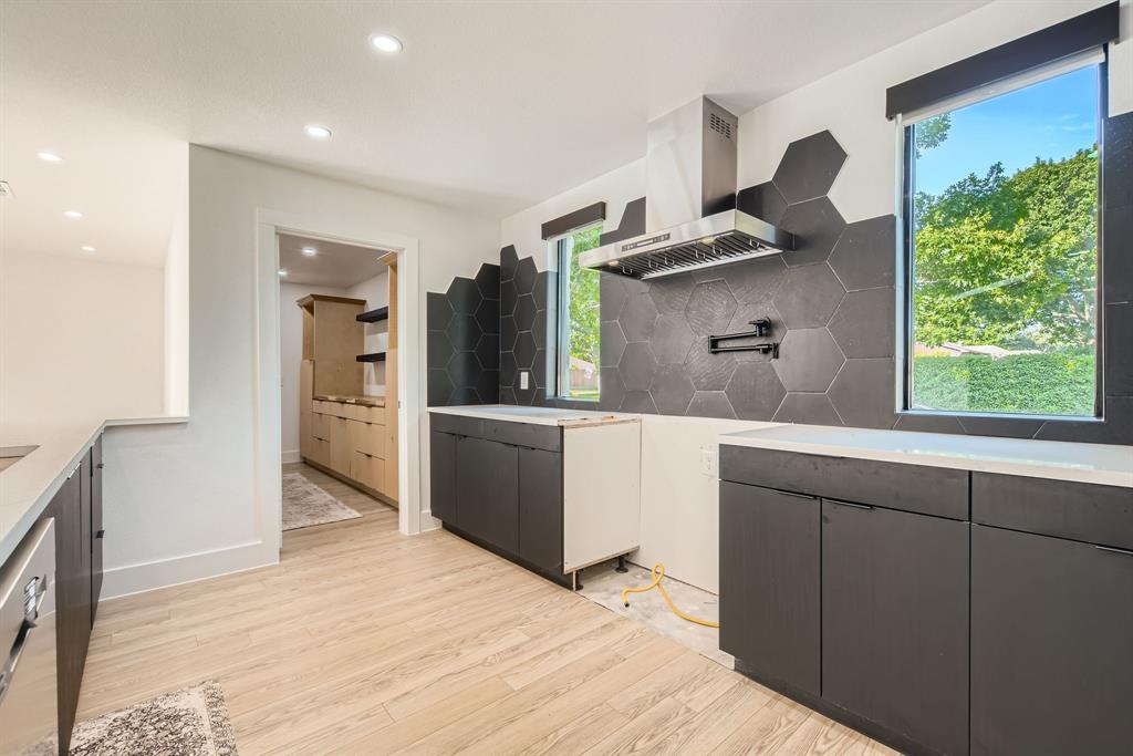 16212 Spring Creek Road Dallas, TX 75248 - Photo 12 of 28 a kitchen with stainless steel appliances granite countertop a refrigerator and a sink