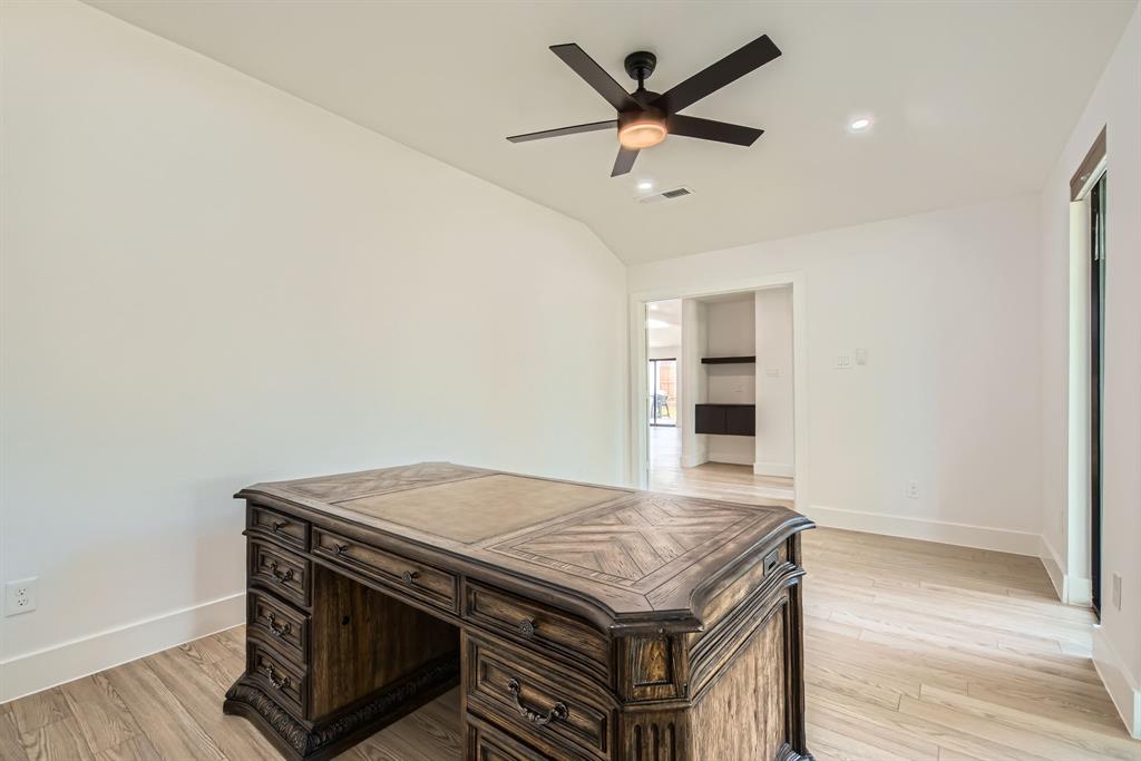 16212 Spring Creek Road Dallas, TX 75248 - Photo 14 of 28 an empty room with wooden floor and ceiling fan