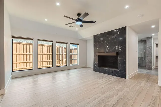 a view of an empty room with a fireplace and a window