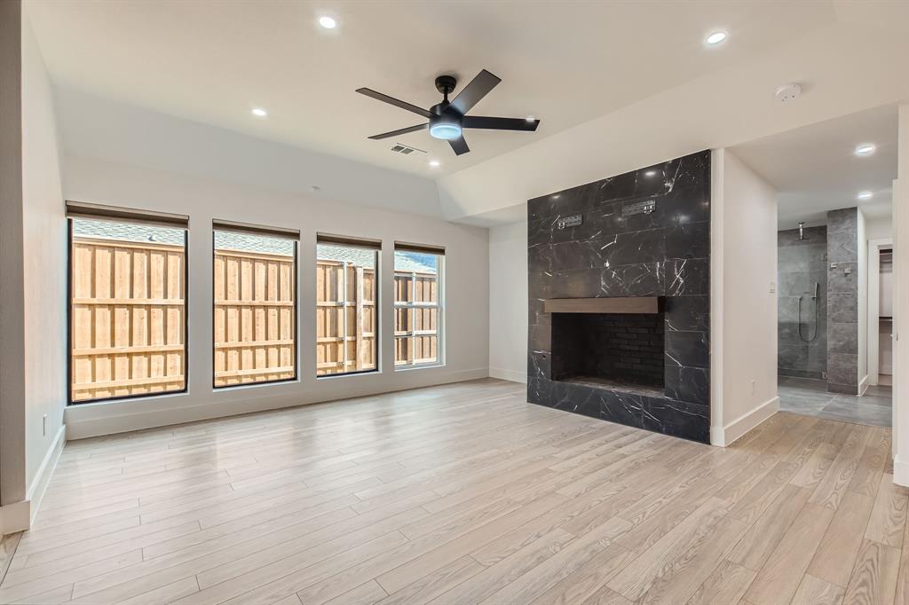 16212 Spring Creek Road Dallas, TX 75248 - Photo 16 of 28 a view of an empty room with a fireplace and a window