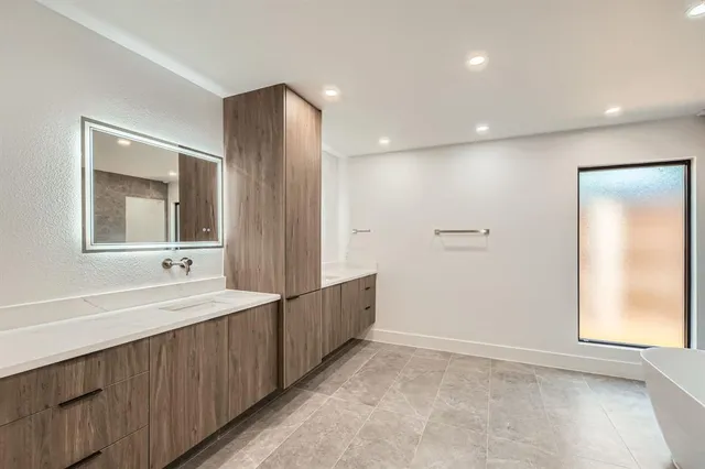 a bathroom with a double vanity sink and a mirror
