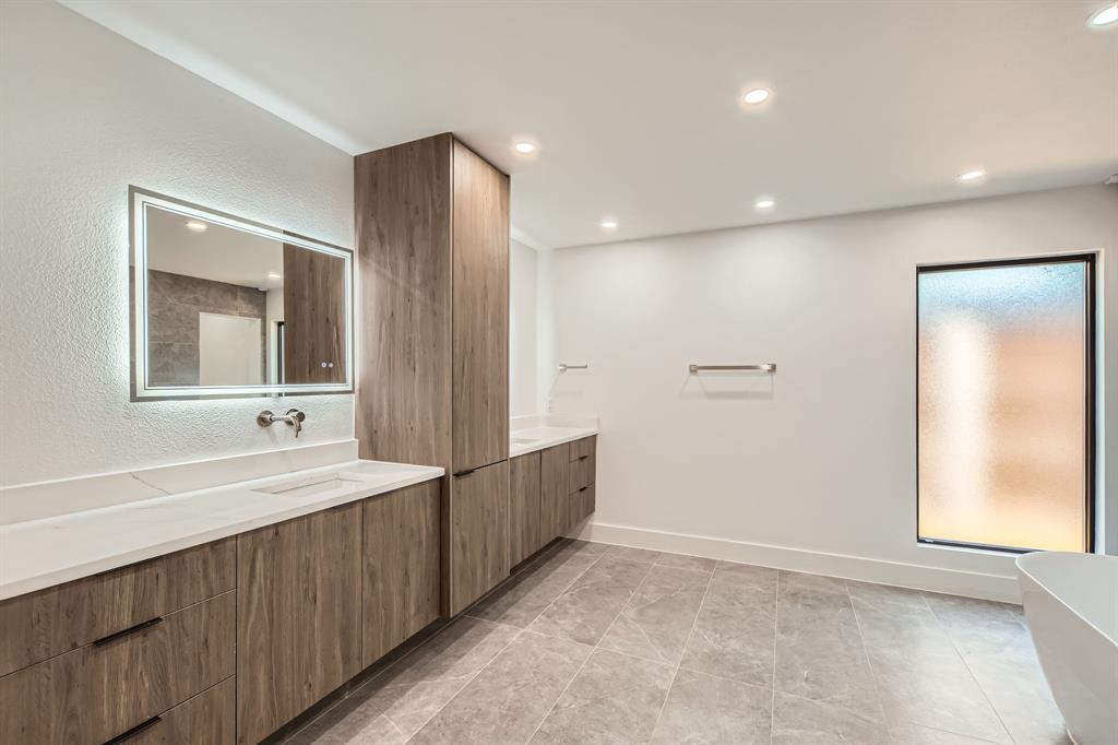 16212 Spring Creek Road Dallas, TX 75248 - Photo 18 of 28 a bathroom with a double vanity sink and a mirror