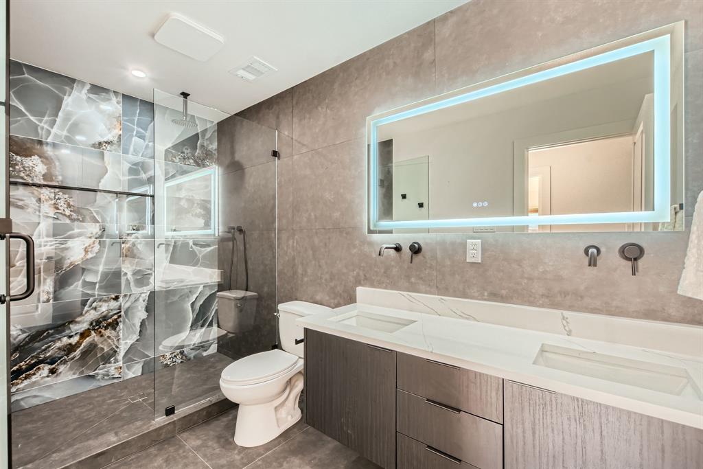 16212 Spring Creek Road Dallas, TX 75248 - Photo 25 of 28 a bathroom with a sink toilet and shower