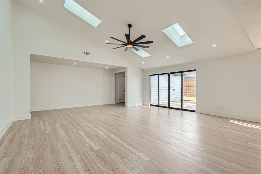 16212 Spring Creek Road Dallas, TX 75248 - Photo 5 of 28 wooden floor in an empty room with a window