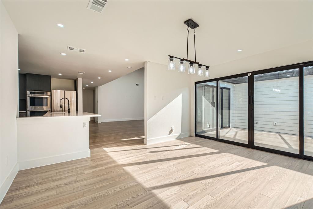 16212 Spring Creek Road Dallas, TX 75248 - Photo 8 of 28 a view of a livingroom with wooden floor and stairs