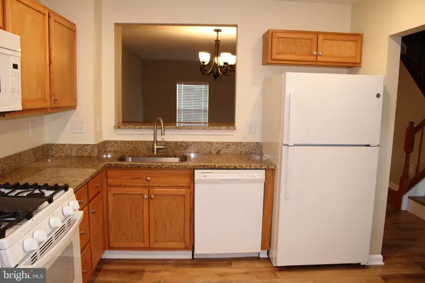 a kitchen with a refrigerator and a sink