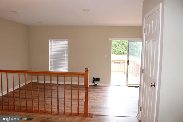 a view of a bedroom with wooden floor