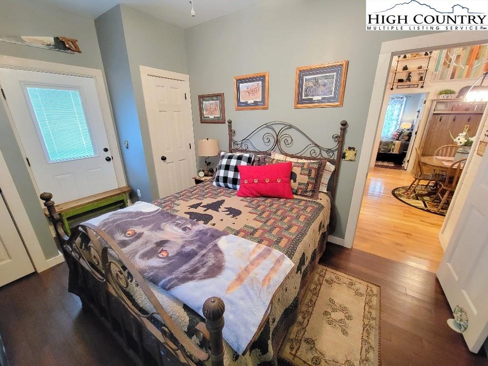 77 Cascades Ridge Ennice, NC 28623 - Photo 18 of 33 a bedroom with a bed and wooden floor