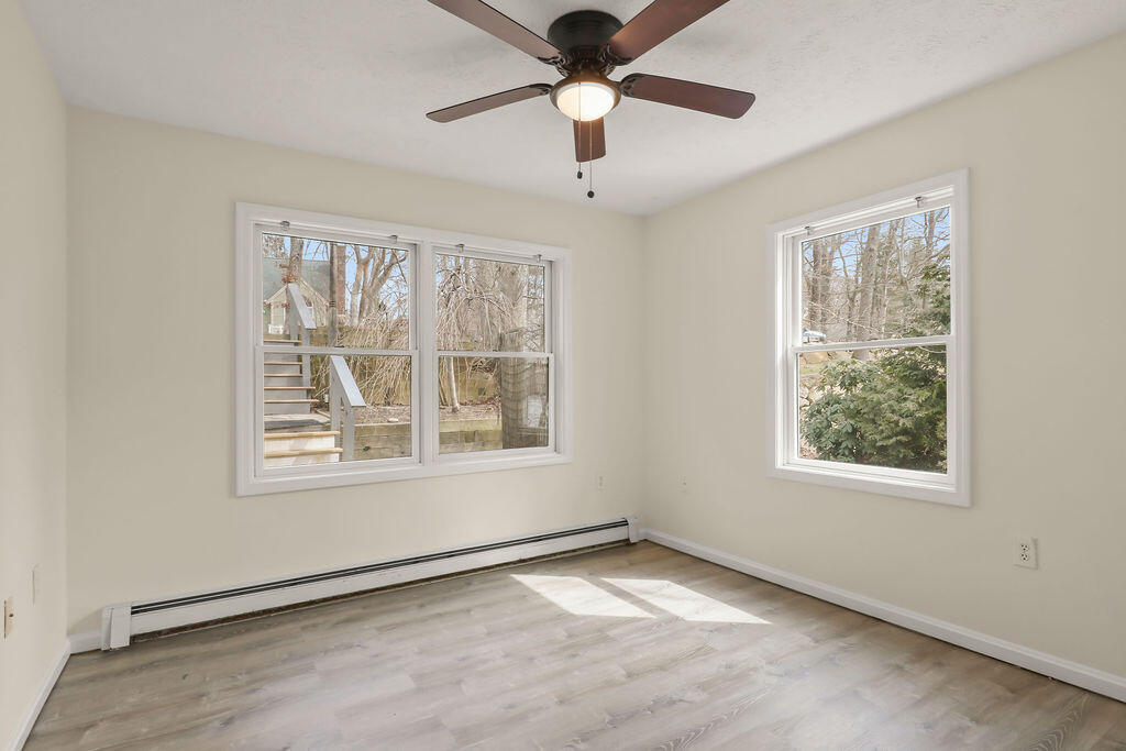 75 Edgewater Road Mashpee, MA 02649 - Photo 27 of 78 an empty room with a window and a ceiling fan