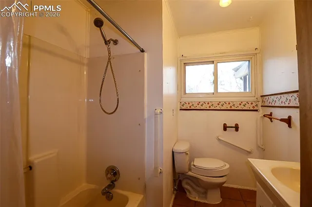 a bathroom with a granite countertop toilet a sink and shower