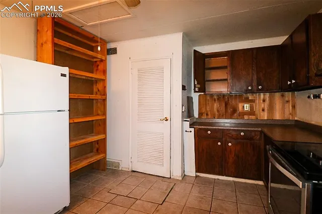 a kitchen with a sink and a refrigerator