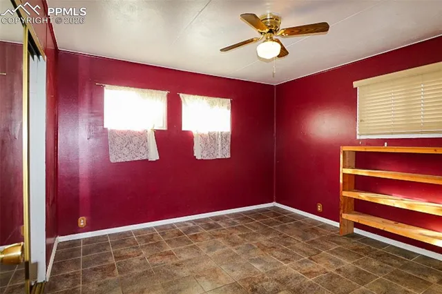 a view of room with a ceiling fan and a window