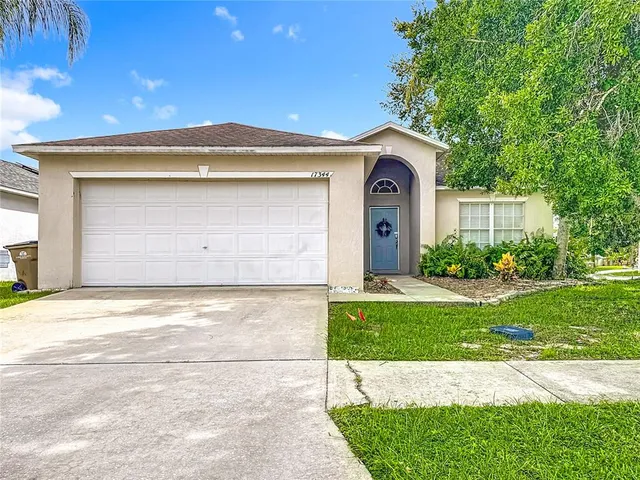a view of a house with a yard and garage