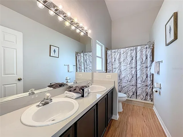 a bathroom with a sink toilet and a mirror
