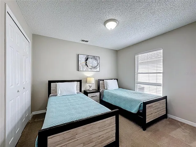 a bedroom with a bed and window