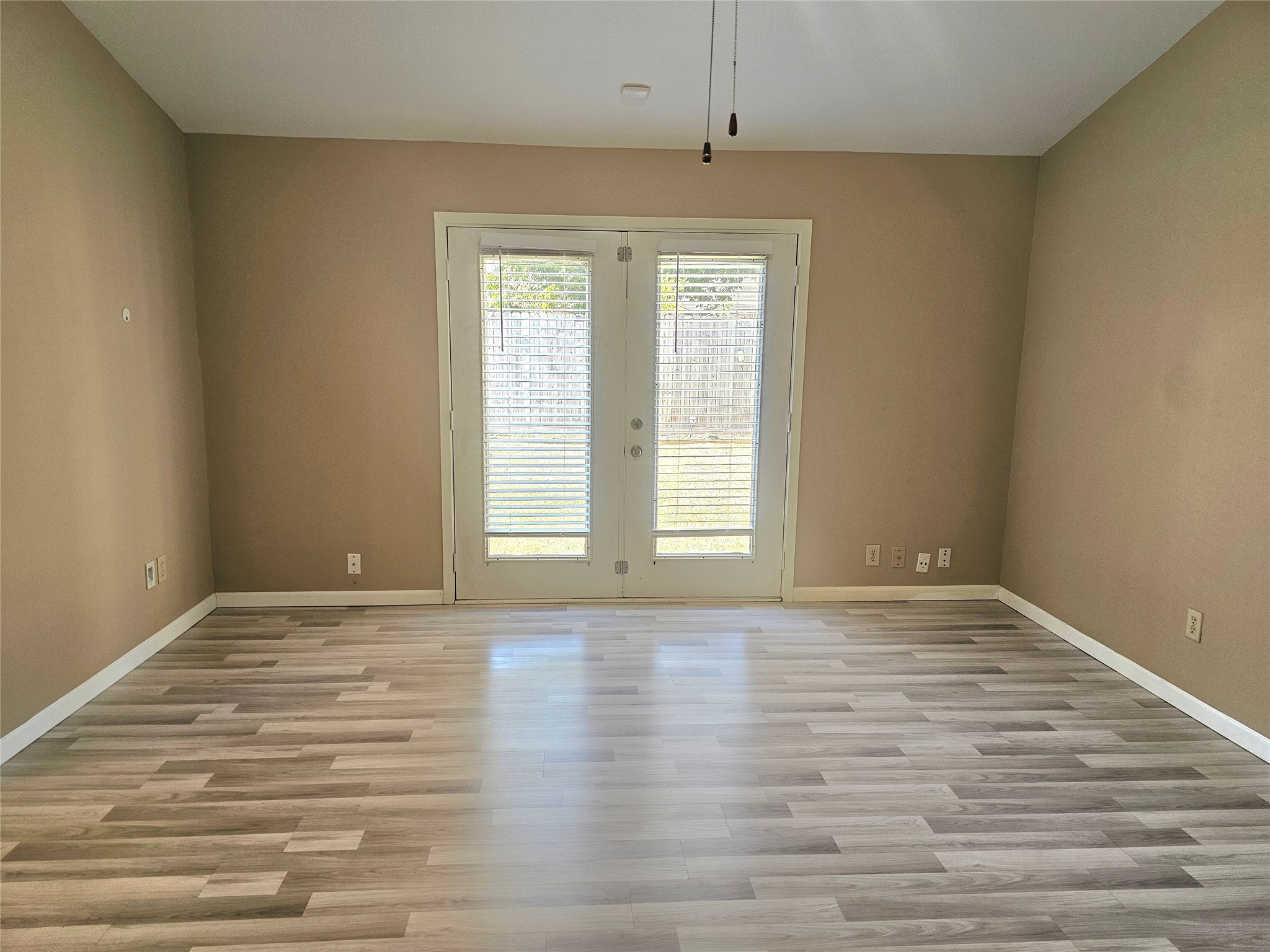 16718 Running Quail Court Houston, TX 77489 - Photo 18 of 33 a view of an empty room with a window and wooden floor