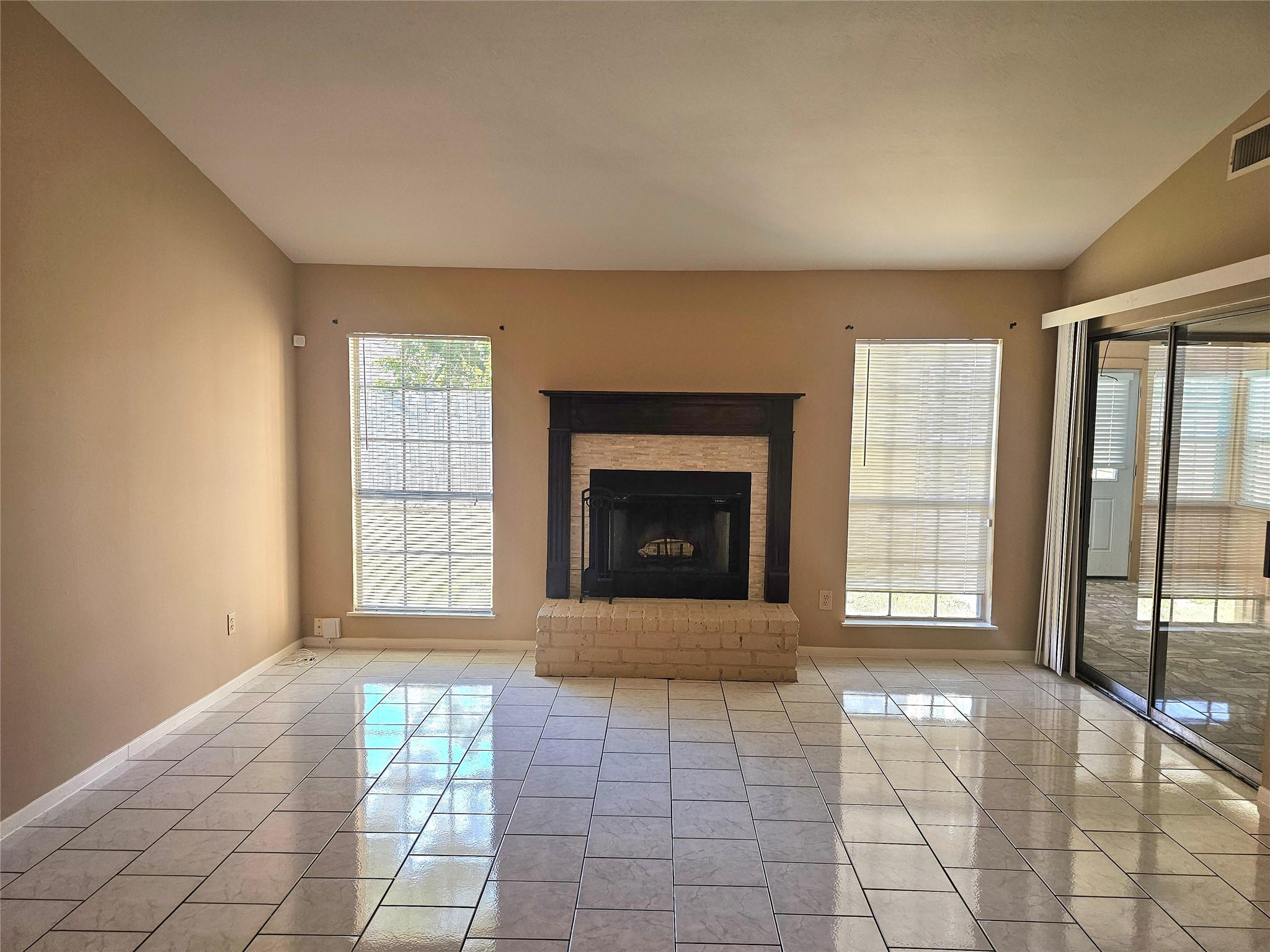16718 Running Quail Court Houston, TX 77489 - Photo 4 of 33 a view of an empty room with a fireplace and a window