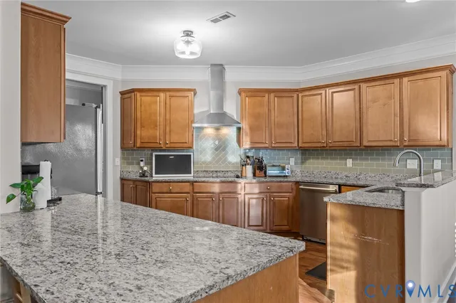 a kitchen with stainless steel appliances a refrigerator sink and cabinets